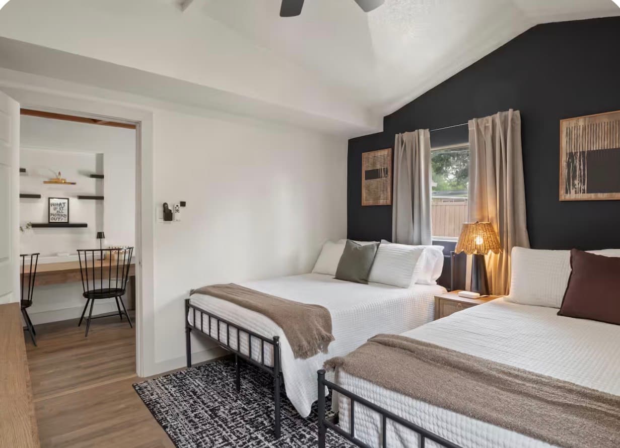 Second bedroom with two beds inside the Dallas Creative Connect location.