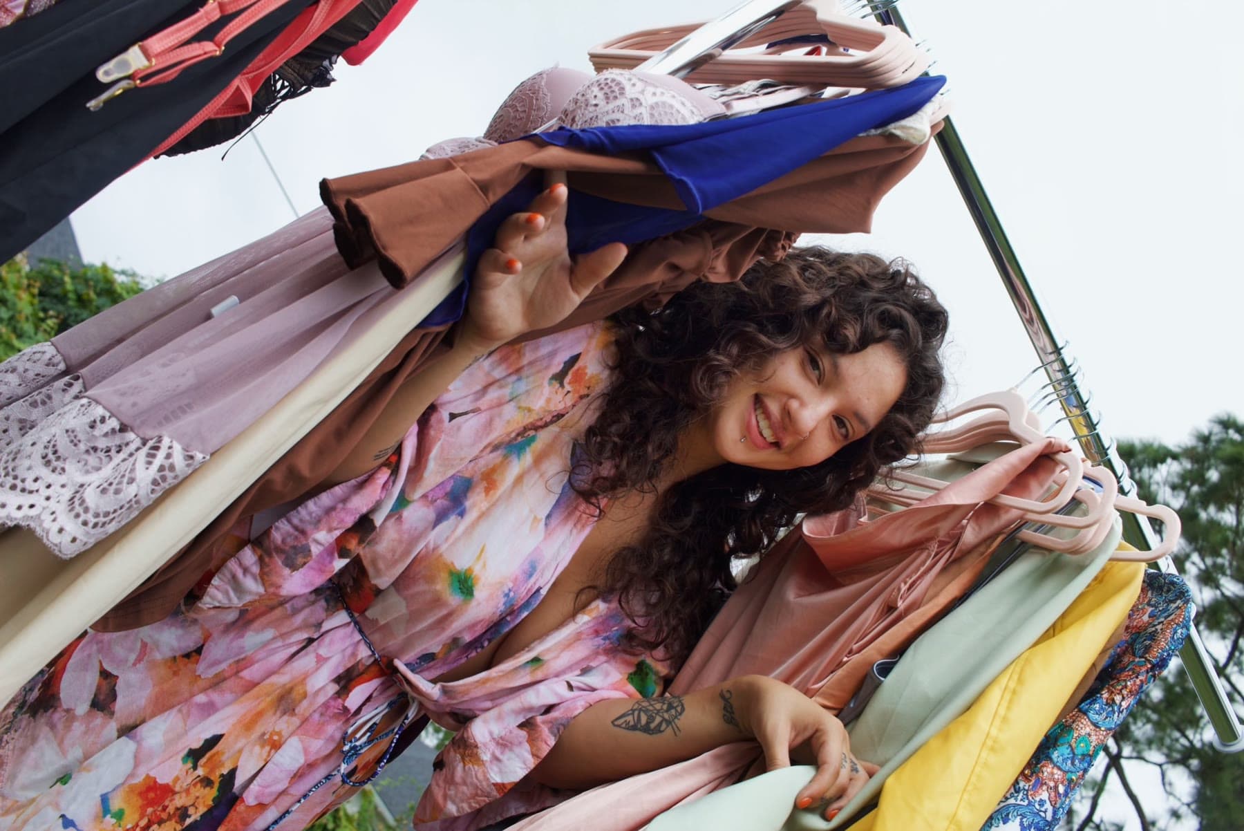 A candid behind-the-scenes moment among wardrobe racks at Creative Connect Palm Bay.